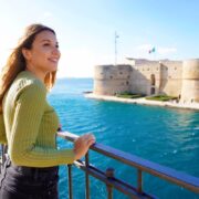 Woman overlooking Castello Aragonese, Taranto, Italy