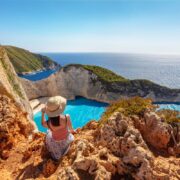 Woman looking over Navagio Beach, Zakynthos, Greece