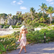 Young Woman Walking The Historical Archaeological Zone In Tulum, Quintana Roo, Mexico