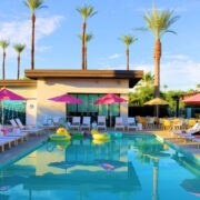 Palm trees and lounge chairs at resort pool in Palm Springs, CA