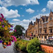 Victorian-era buildings line a busy street in Inverness, Scotland during summer