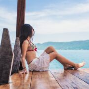 Woman sitting and admiring the view of Coatepeque Lake in El Salvador