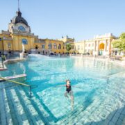 Young woman swimming at the famous Szechenyi thermal bathes. It is one of the biggest natural hot spring spa baths in Europe